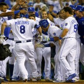 Jun 6, 2017; Kansas City, MO, USA; Kansas City Royals players congratulate designated hitter Mike Moustakas (8) at home plate after hitting a walk-off home run against the Houston Astros in the ninth inning at Kauffman Stadium. The Royals won 9-7. Mandatory Credit: Jay Biggerstaff-USA TODAY Sports