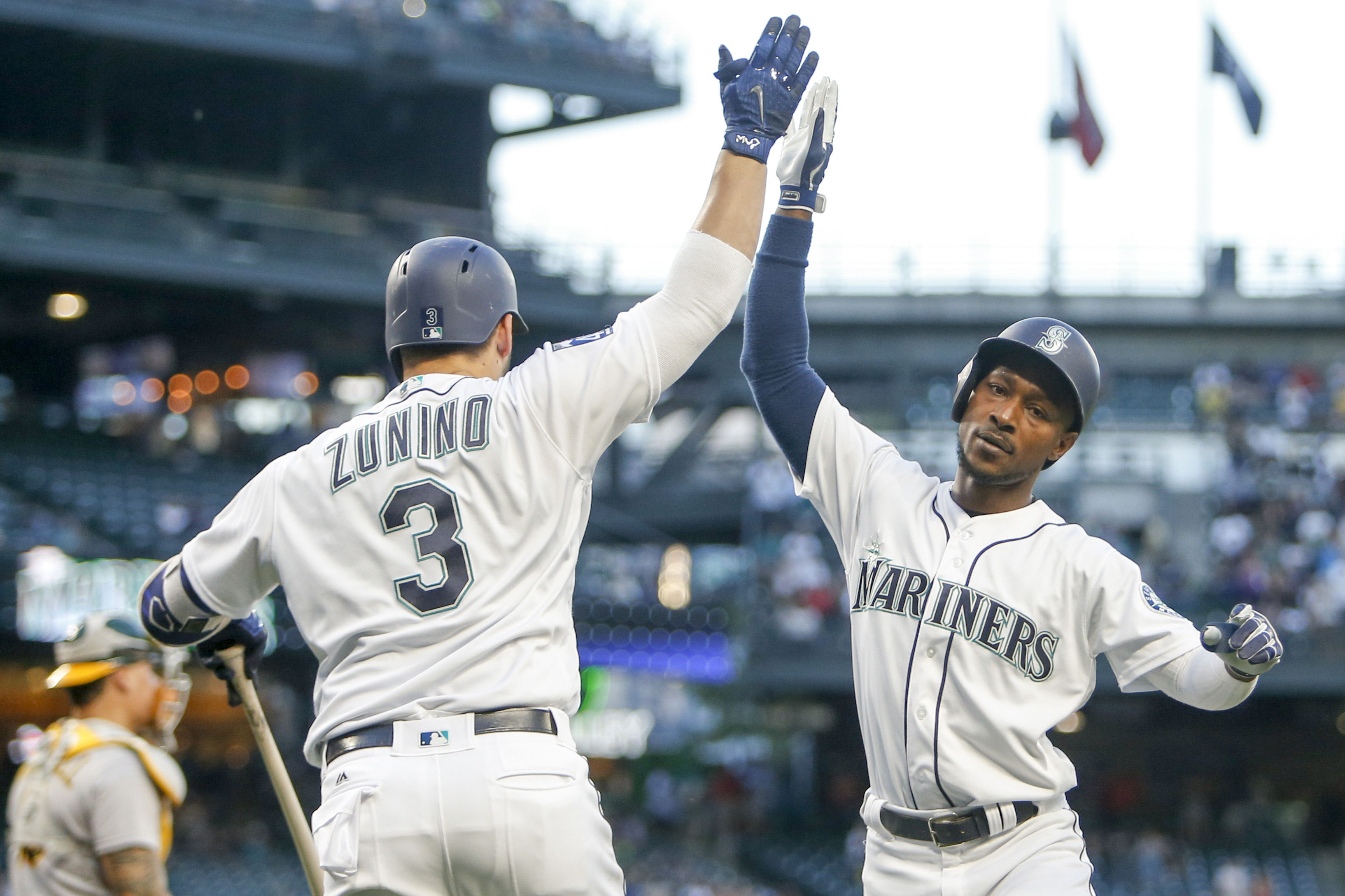 Jul 8, 2017; Seattle, WA, USA; Seattle Mariners center fielder Jarrod Dyson (1) high fives catcher Mike Zunino (3) after hitting a solo home run against the Oakland Athletics during the fifth inning at Safeco Field. Mandatory Credit: Joe Nicholson-USA TODAY Sports
