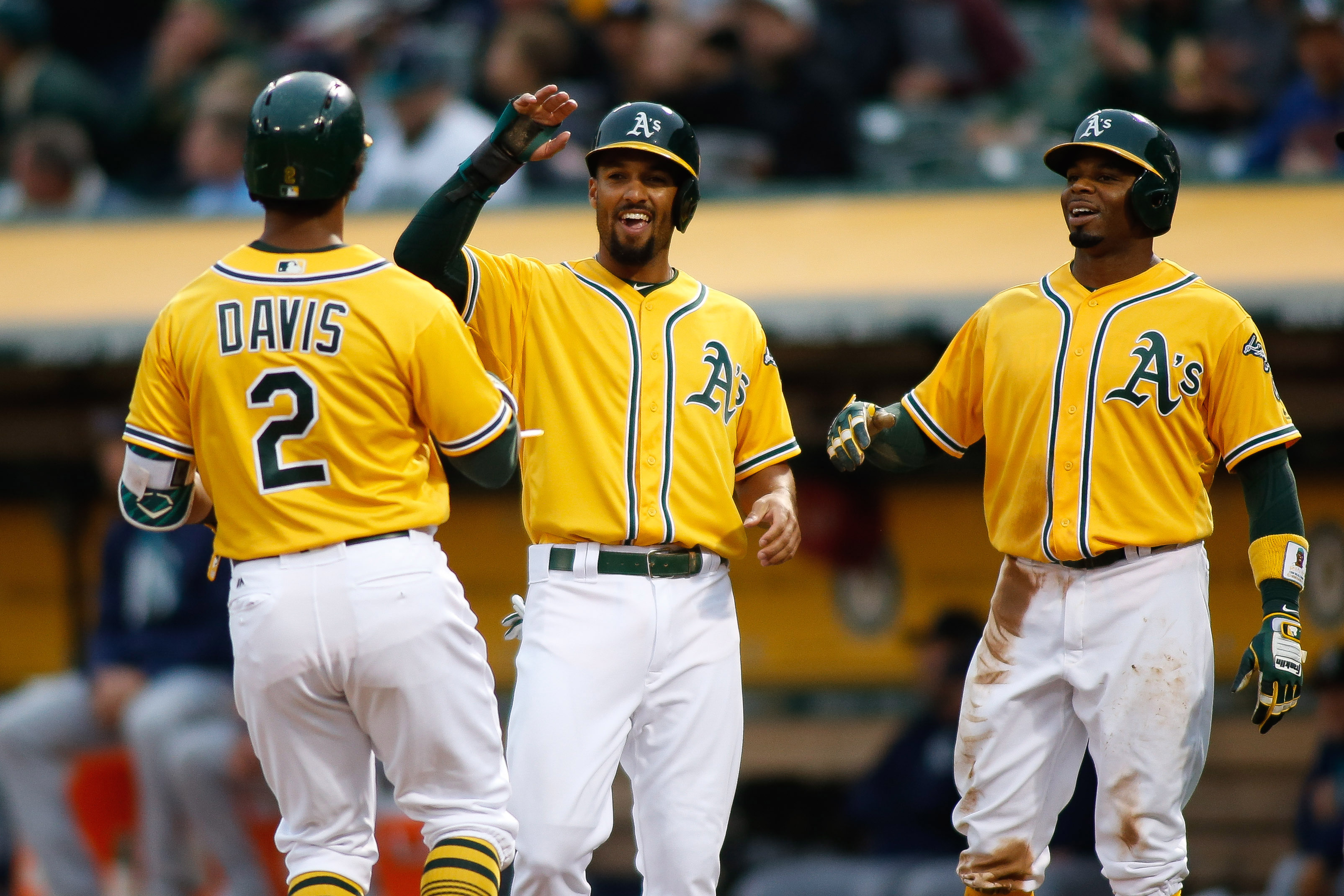 Aug 8, 2017; Oakland, CA, USA; Oakland Athletics left fielder Khris Davis (2) is greeted by shortstop Marcus Semien (10) and center fielder Rajai Davis (11) after hitting a home run against the Seattle Mariners during the first inning at Oakland Coliseum. Mandatory Credit: Stan Szeto-USA TODAY Sports