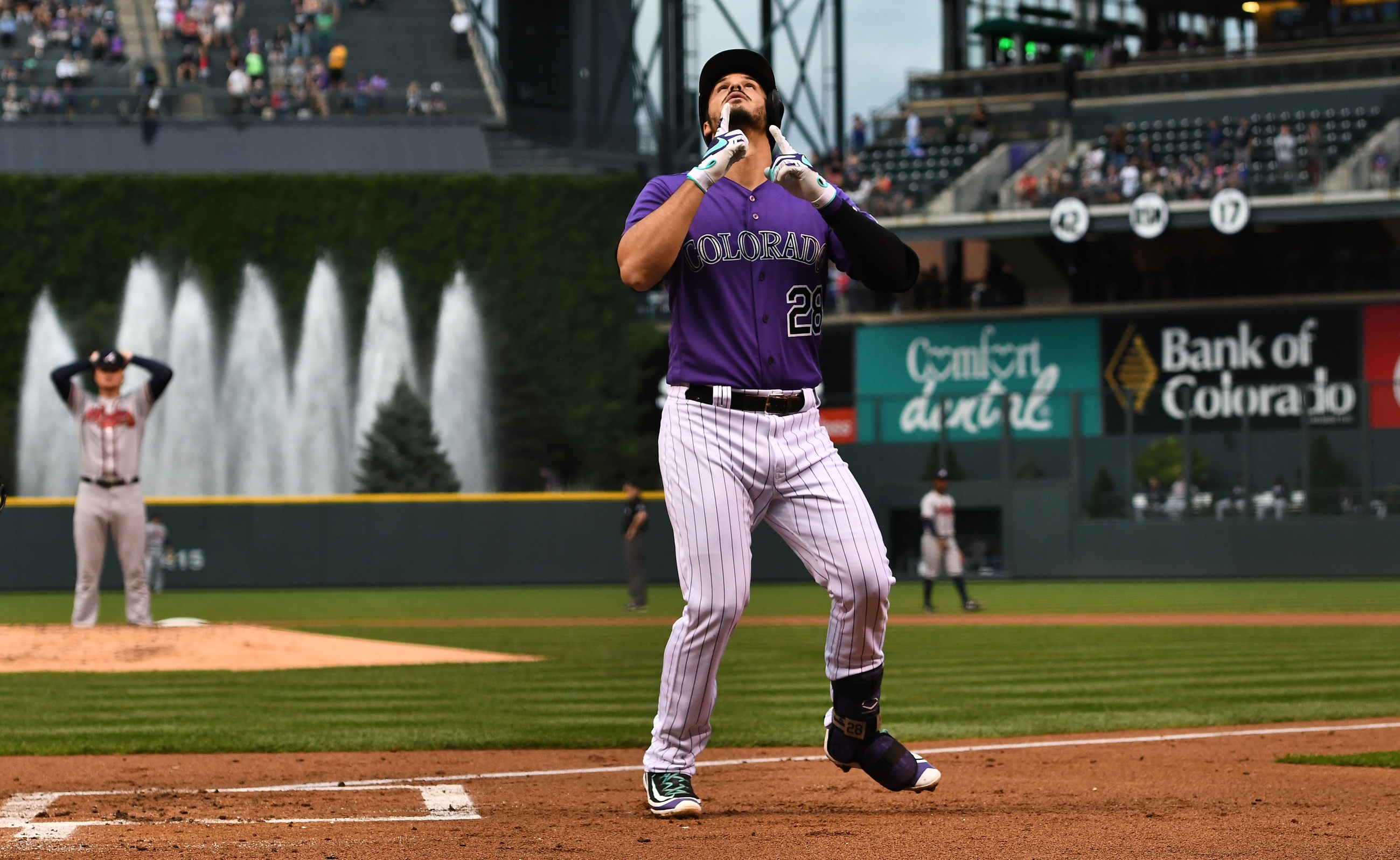 Aug 15, 2017; Denver, CO, USA; Colorado Rockies third baseman Nolan Arenado (28) is celebrates his solo home run in the first inning against the Atlanta Braves at Coors Field. Mandatory Credit: Ron Chenoy-USA TODAY Sports