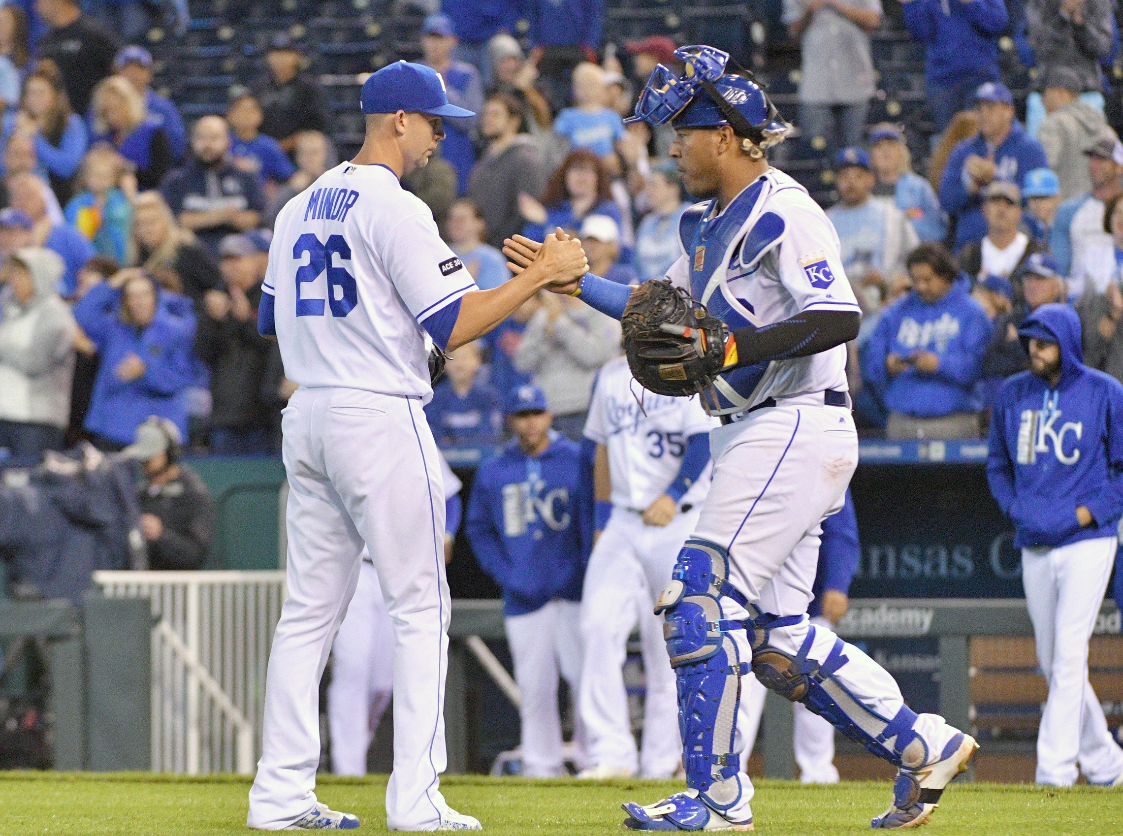 Sep 26, 2017; Kansas City, MO, USA; Kansas City Royals relief pitcher Mike Minor (26) is congratulated by catcher Salvador Perez (13) after a win over the Detroit Tigers at Kauffman Stadium. Mandatory Credit: Denny Medley-USA TODAY Sports