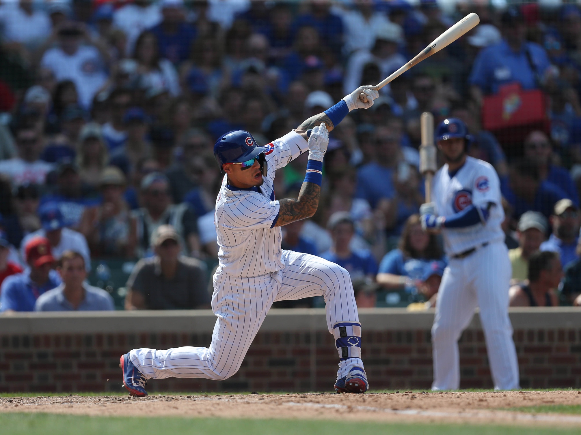 Aug 4, 2018; Chicago, IL, USA; Chicago Cubs third baseman Javier Baez (9) hits a single during the seventh inning against the San Diego Padres at Wrigley Field. Mandatory Credit: Dennis Wierzbicki-USA TODAY Sports